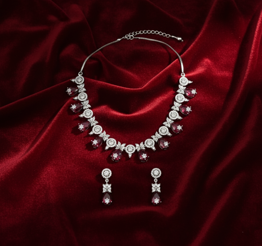 Jewelry set with necklace and earrings on a red satin background