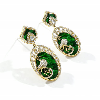 Pair of green and gold earrings with a white background