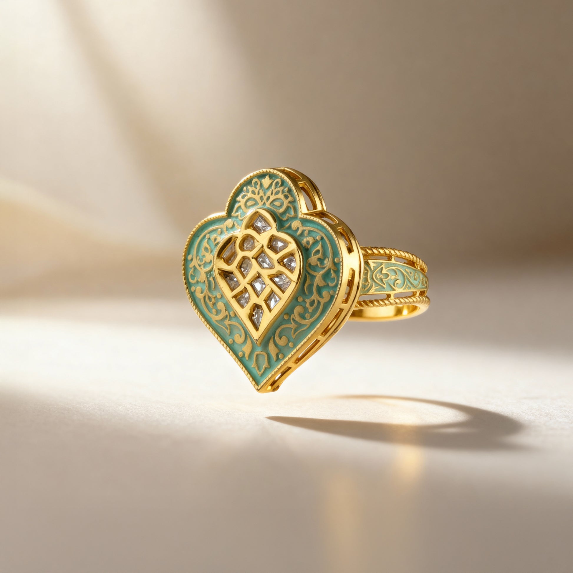 Gold and green heart-shaped ring with intricate design on a beige background