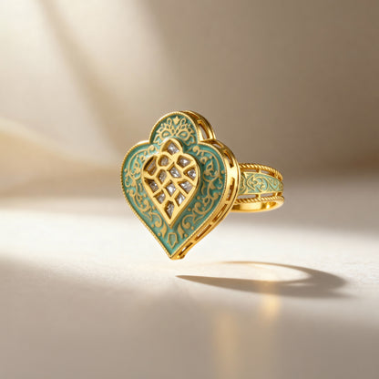 Gold and green heart-shaped ring with intricate design on a beige background