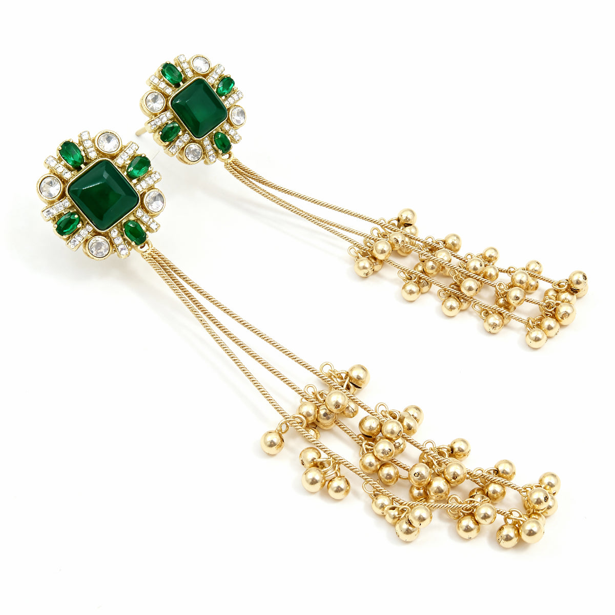 Gold earrings with green gemstones on a white background