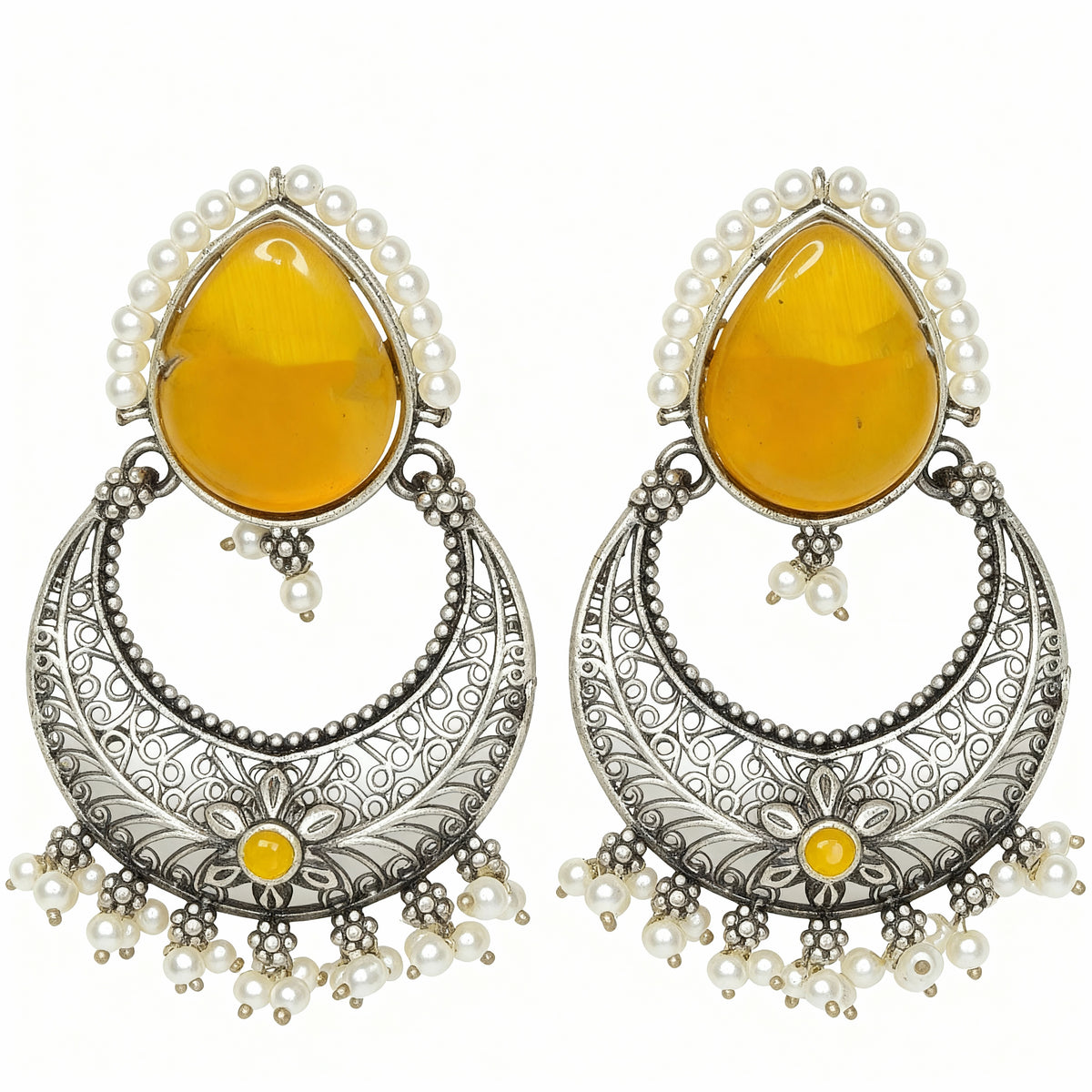 Pair of earrings with yellow teardrop stones and silver floral designs on a white background