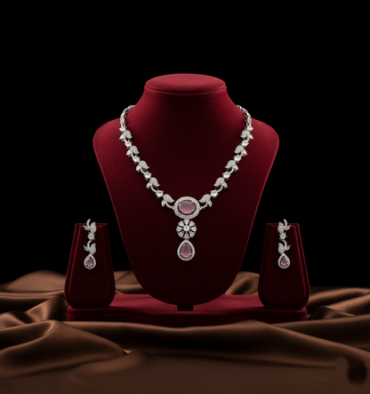 Jewelry set with necklace and earrings on a red velvet stand against a dark background