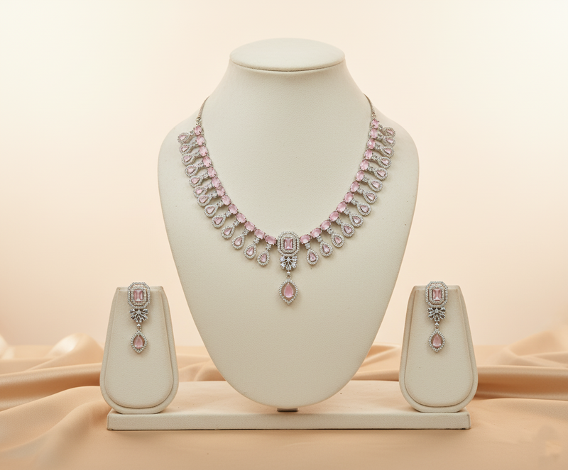 Necklace set with pink gemstones on a mannequin bust against a beige background