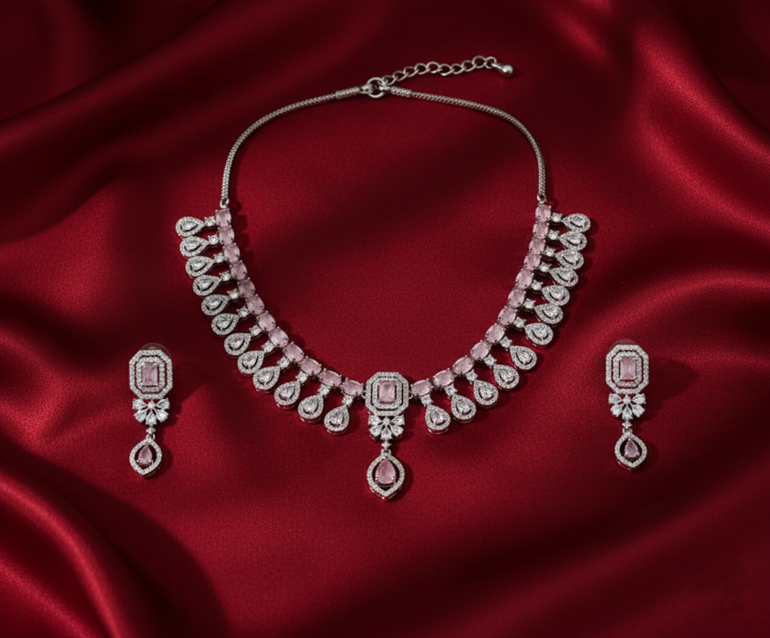 Diamond necklace and earrings set on a red satin background
