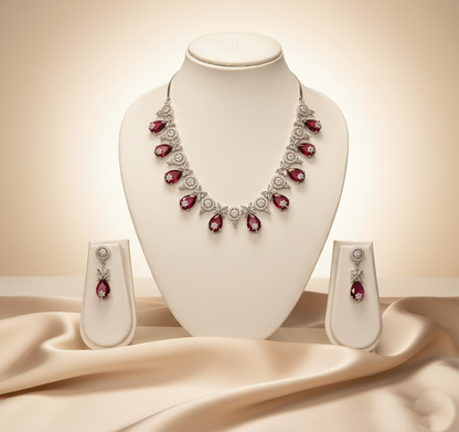 Jewelry set with necklace and earrings on a mannequin bust against a beige background