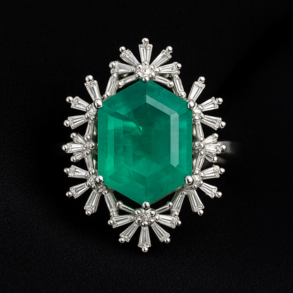 Emerald green gemstone surrounded by silver and diamond-like elements on a black background