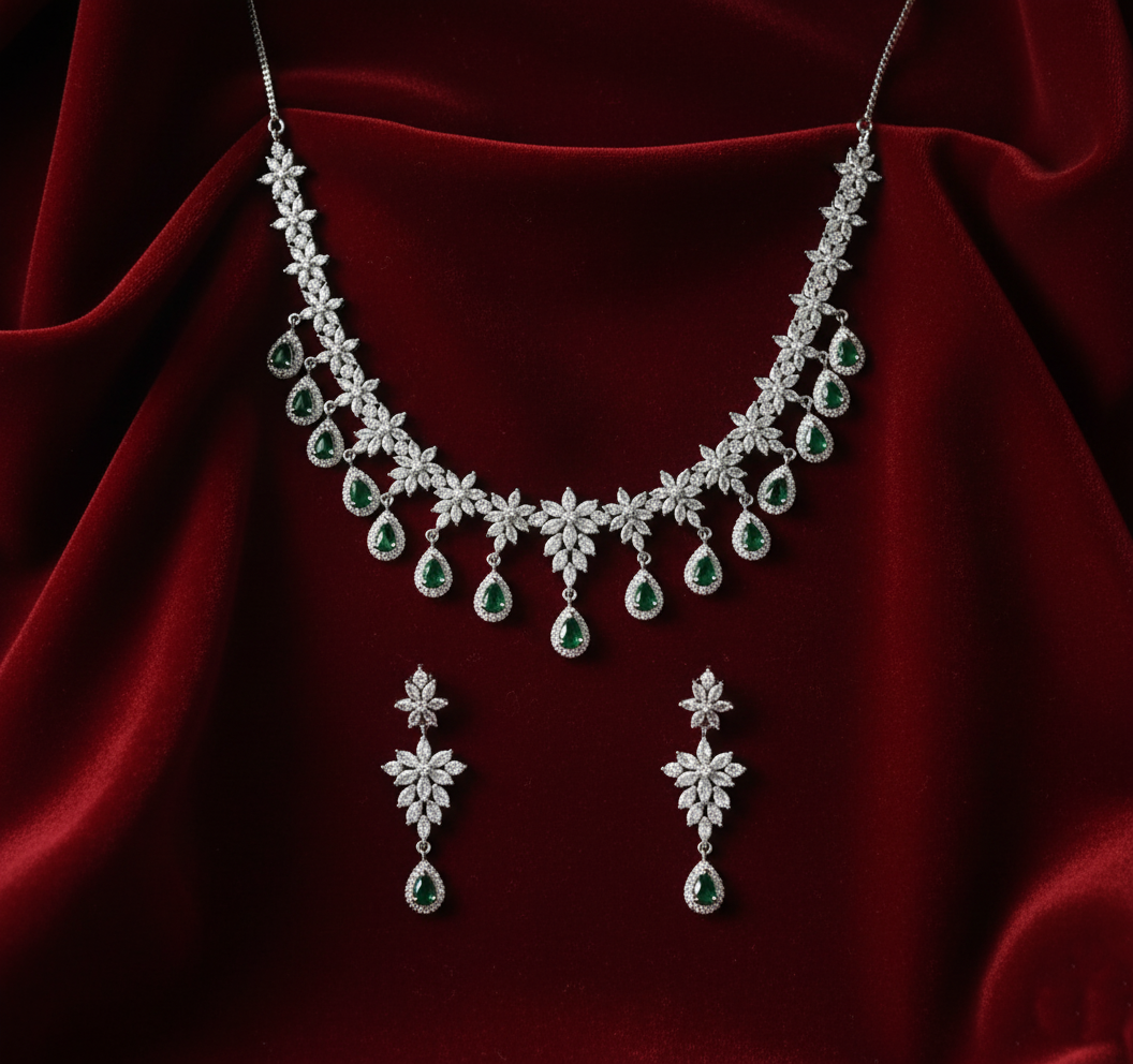 Diamond necklace and earrings set on a red fabric background