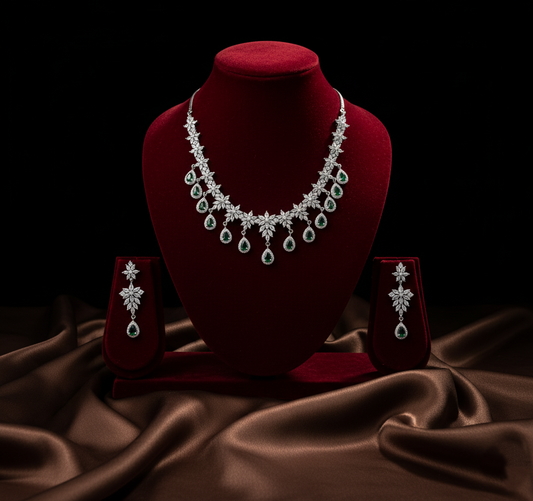 Jewelry set with necklace and earrings on a red velvet stand against a dark background.