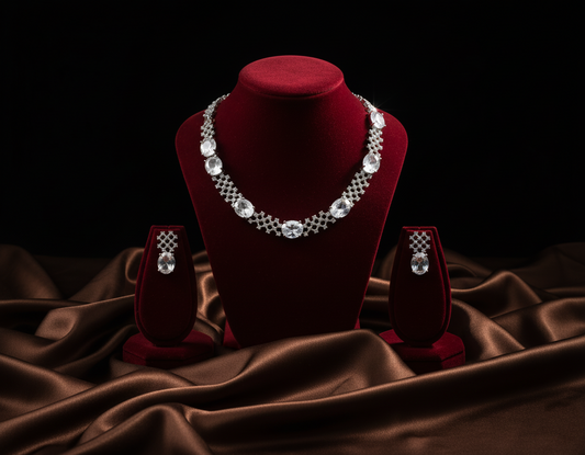Jewelry set with necklace and earrings on a red velvet stand against a dark background