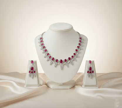 Jewelry set with necklace and earrings on a white stand against a beige background