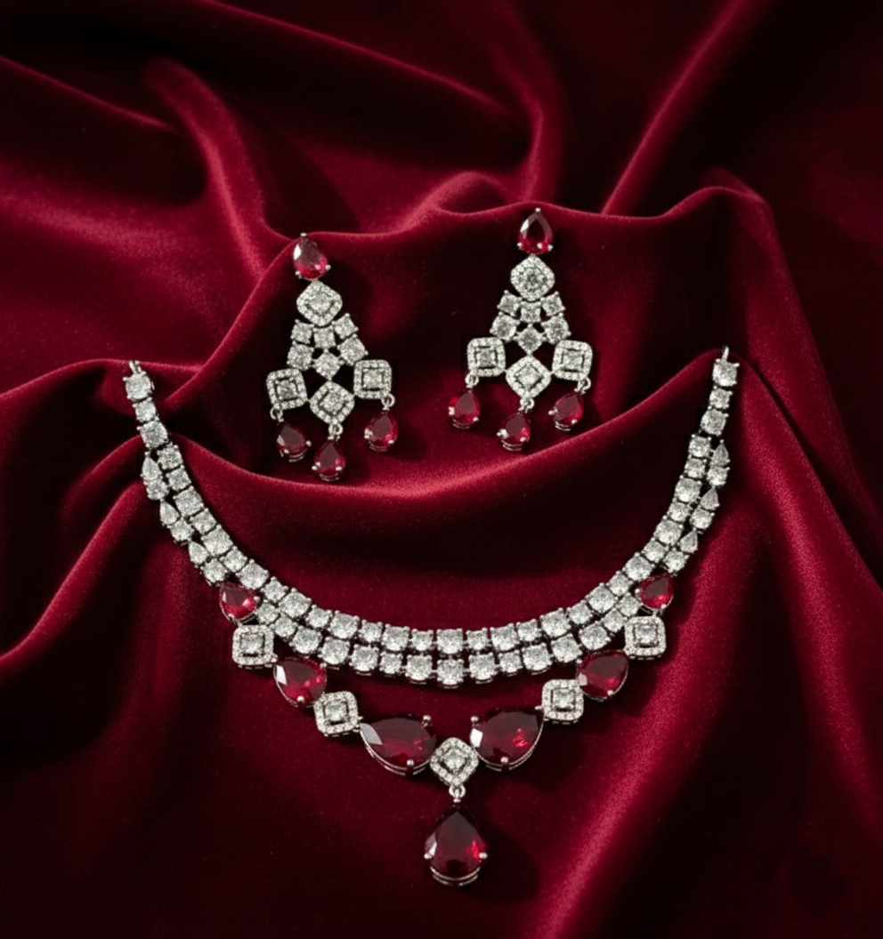 Jewelry set with necklace and earrings on a red fabric background