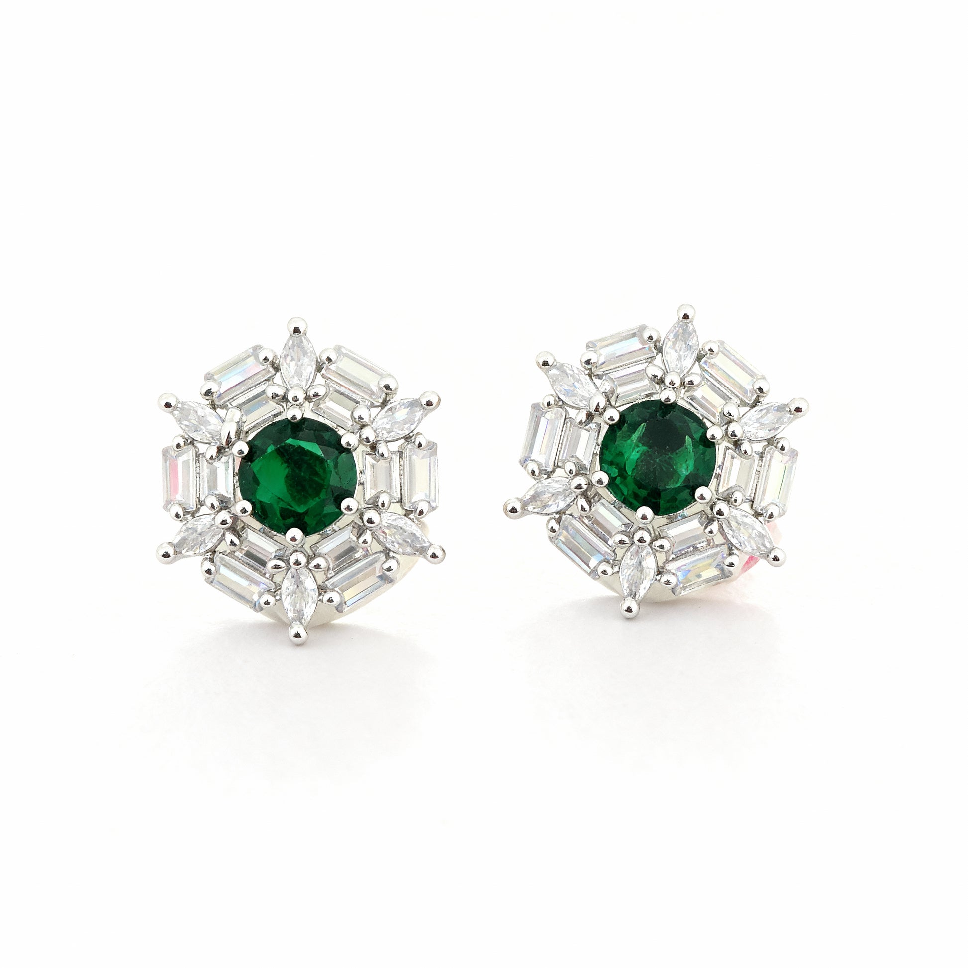 Pair of earrings with green gemstones and silver accents on a white background