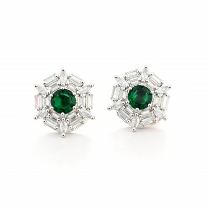 Pair of earrings with green gemstones and silver accents on a white background
